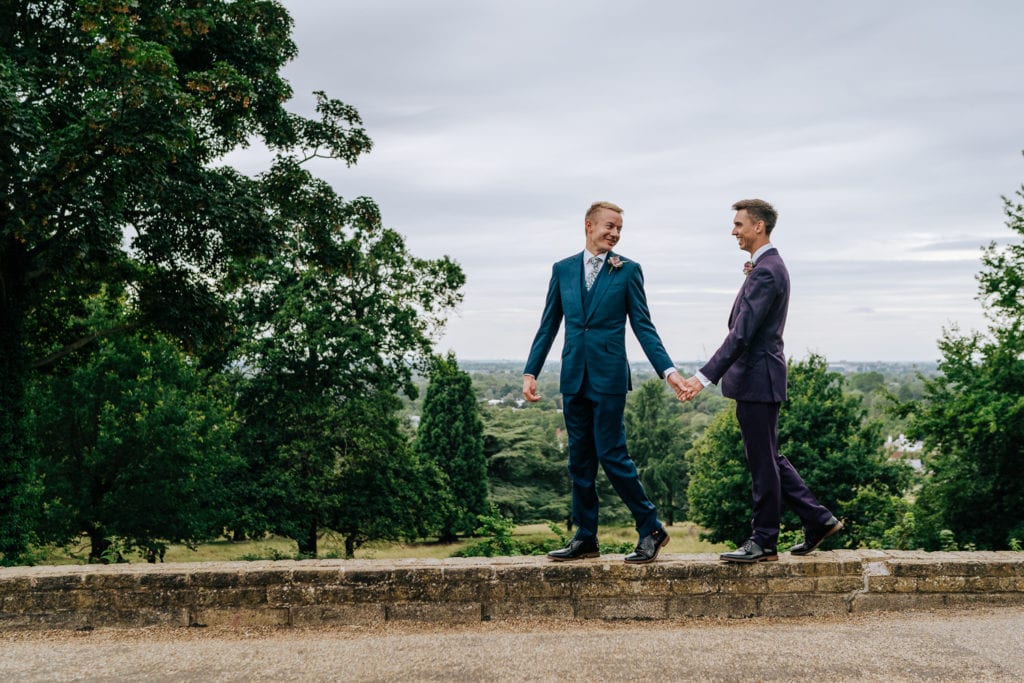 gay couple walking through Pembroke Lodge wedding venue
