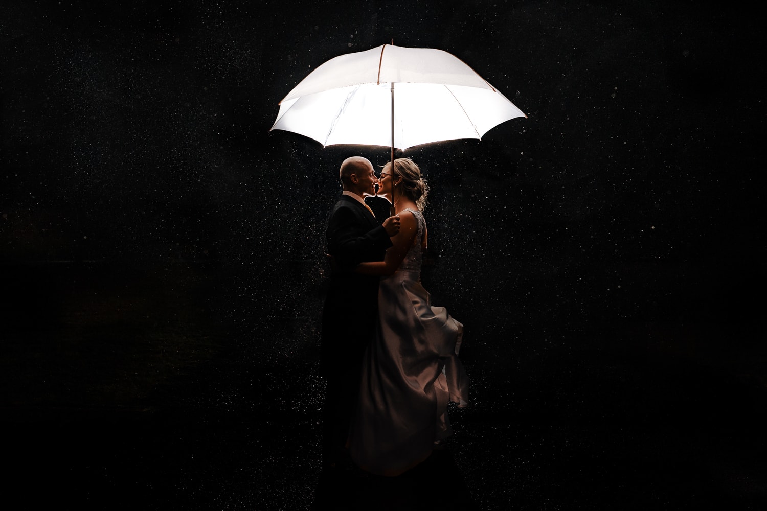 bride and groom creative night portrait in the rain