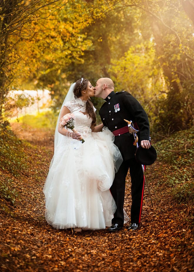 army officer and his bride walking during autumn romantic wedding