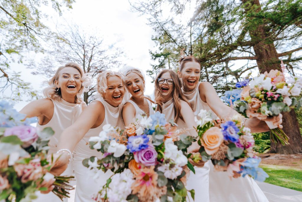 Bridesmaids celebrating together after the wedding ceremony during the drinks reception