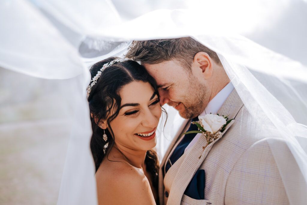 Couple enjoying relaxed portraits together during their UK wedding day