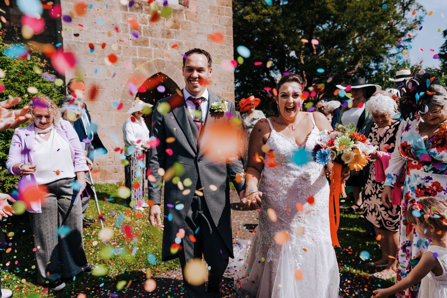 bride and groom walk through a sea of confetti | Kent Wedding Photographer | Alex Buckland Photography