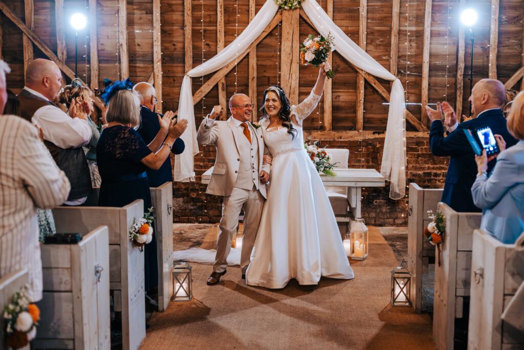 Bride and Groom celebrating at a UK wedding venue after the ceremony