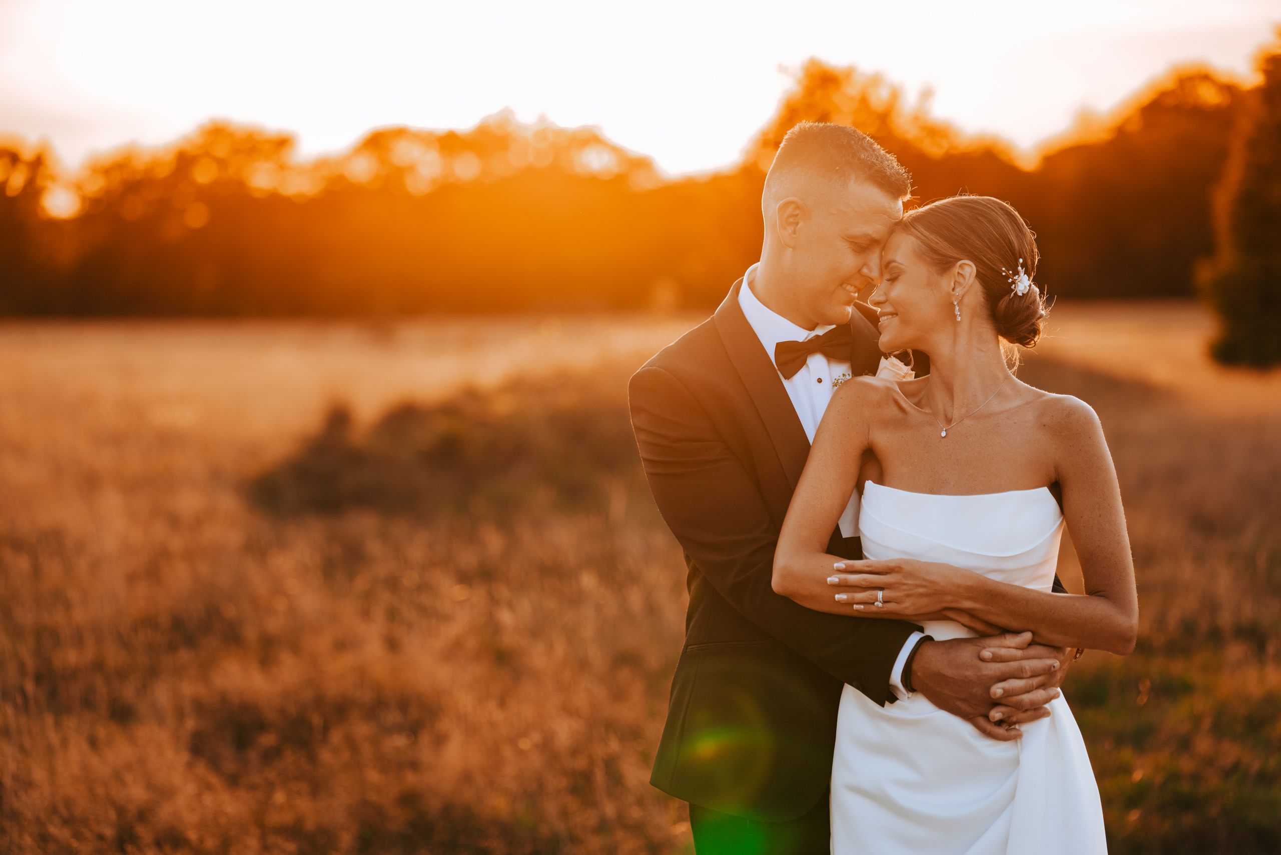 Relaxed couple portrait during a UK wedding, photographed in soft evening light