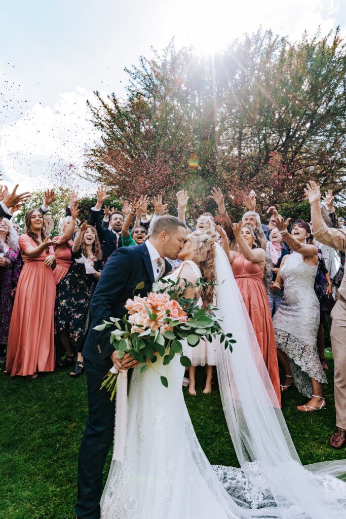 south east wedding photo of bride and groom being showered by confetti