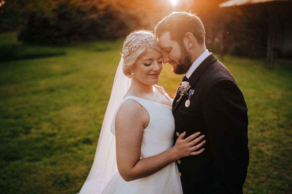 Bride and groom embracing at sunset, military wedding photography in East Sussex by Alex Buckland Photography