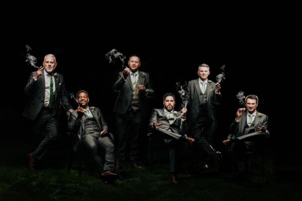 Bold editorial style groom and groomsmen portrait with cigars shot by Alex Buckland Photography