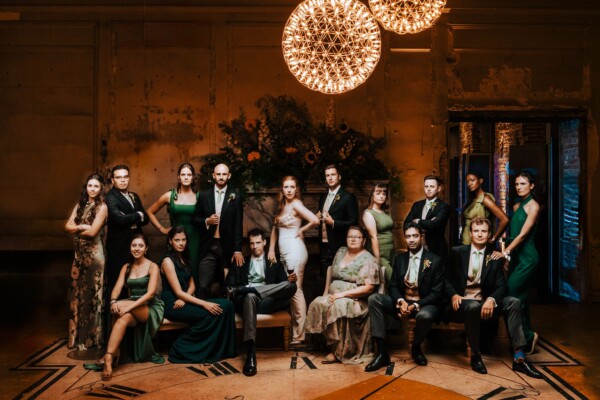 Evening wedding party group image with warm ambient light and coordinated posing
