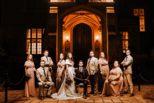 Formal wedding party portrait at a stately venue with cinematic lighting