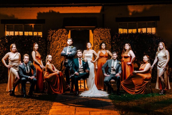 Sunset wedding party group portrait with elegant styling and warm colour tones